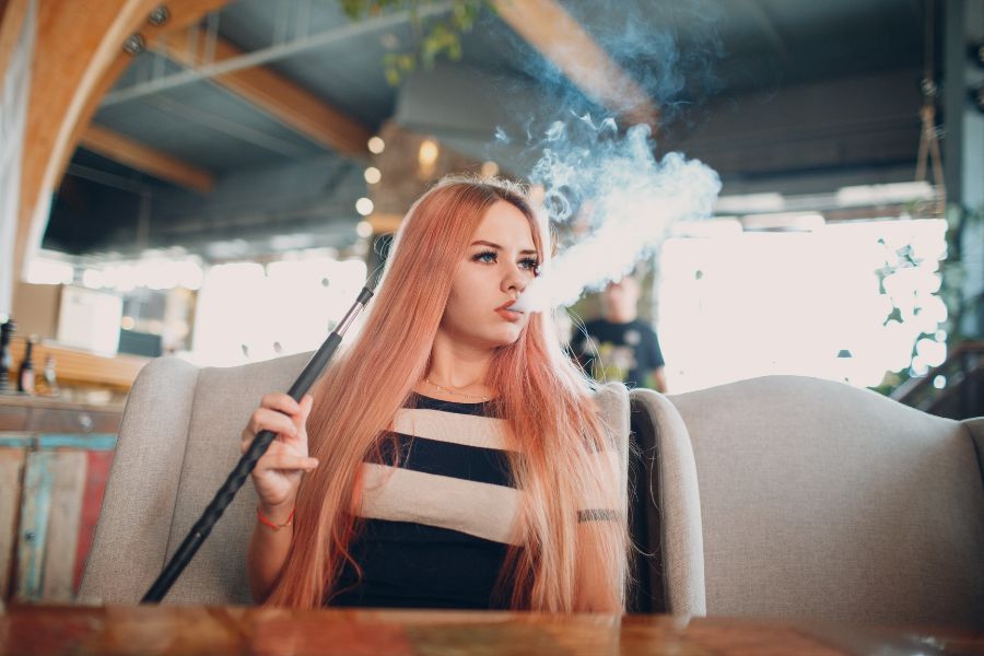 A lady smoking shisha