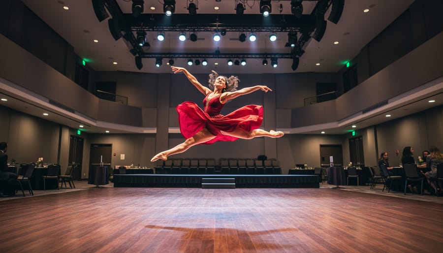 Dancer performing on the Queen Elizabeth Theatre stage with dramatic lighting
